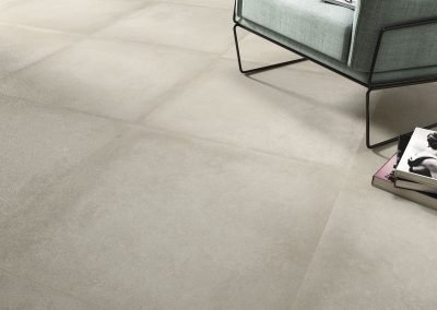 close up of beige square stone floor tiles from design di lusso watford tile shop